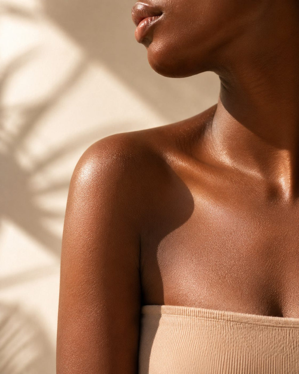 Sunlight across shoulder and collarbone — sun care at Nwonane